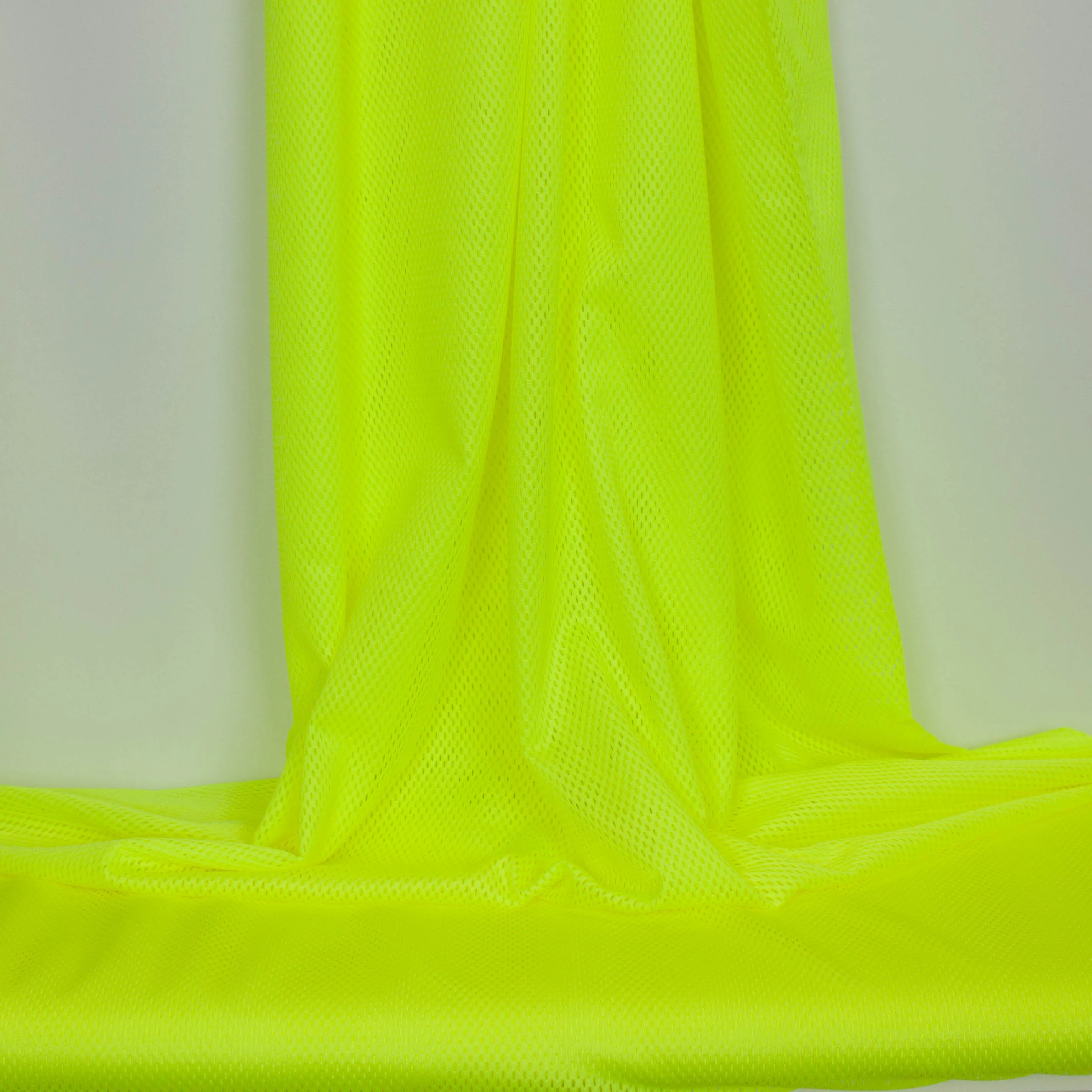 Polyester stretch met gaatjes fluo geel
